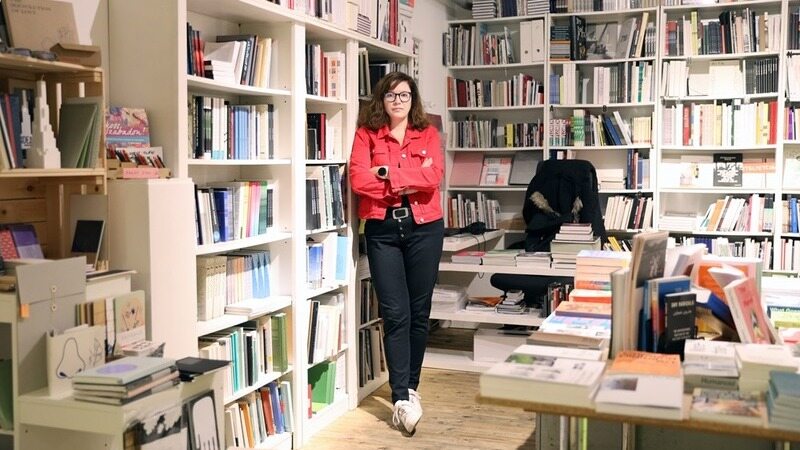 Woman in front on bookcases